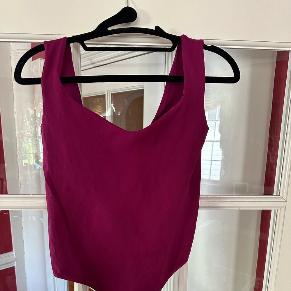 Free People bodysuit tank. Lined shelf bra. M/L. Plum color. Never worn